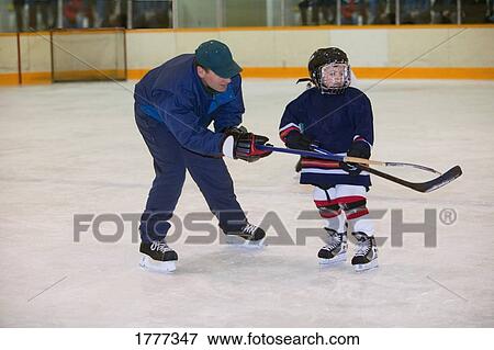 A coach and hockey player on the ice View Large Photo Image Stock Photo - A coach and hockey player on the ice. Fotosearch