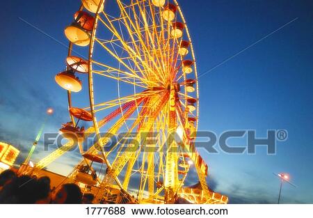 Stock Photo - A Ferris wheel at night. Fotosearch