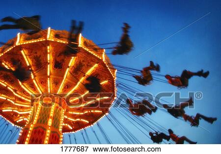 A giant swing at an amusement park at night View Large Photo Image Stock Photo - A giant swing at an amusement park at night. Fotosearch