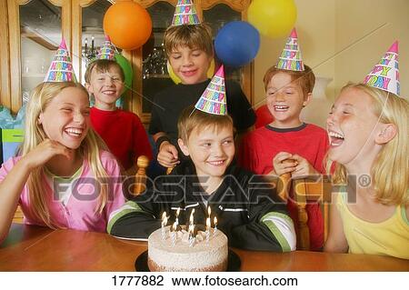 A group of children celebrating a birthday View Large Photo Image Stock Image - A group of children celebrating a birthday. Fotosearch