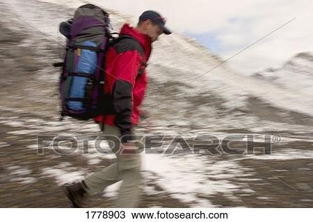 A hiker walking through mountains View Large Photo Image Stock Image - A hiker walking through mountains. Fotosearch