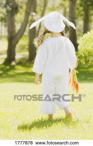 A little girl in a bunny costume with her back to the camera. View Large Photo Image Stock Photo - A little girl in a bunny costume with her back to the camera.. Fotosearch