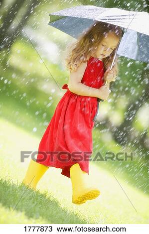A little girl walking in the rain in a red dress, holding an umbrella View Large Photo Image Stock Image - A little girl walking in the rain in a red dress, holding an umbrella. Fotosearch