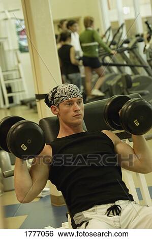 A man doing bicep curls View Large Photo Image Stock Photograph - A man doing bicep curls. Fotosearch