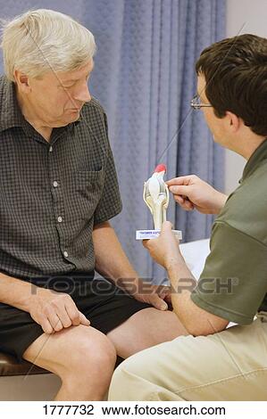 A medical professional explaining a concept to a senior patient View Large Photo Image Stock Image - A medical professional explaining a concept to a senior patient. Fotosearch