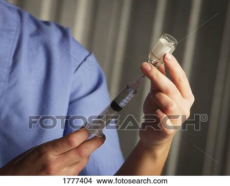 A nurse filling a medical needle View Large Photo Image Picture - A nurse filling a medical needle. Fotosearch