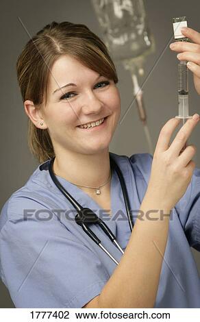 A nurse filling a medical needle View Large Photo Image Stock Image - A nurse filling a medical needle. Fotosearch
