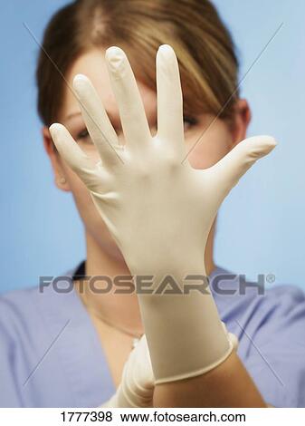 A nurse wearing a rubber glove View Large Photo Image Stock Photo - A nurse wearing a rubber glove. Fotosearch