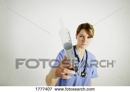 Stock Photo - A nurse with a needle. Fotosearch