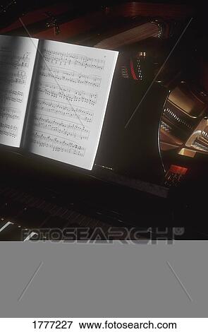 A piano keyboard and sheet music View Large Photo Image Stock Photo - A piano keyboard and sheet music. Fotosearch