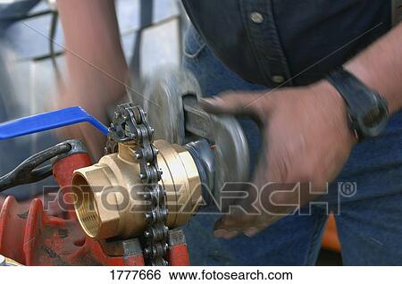 A plumber or gas fitter working with a ball valve View Large Photo Image Stock Photograph - A plumber or gas fitter working with a ball valve. Fotosearch