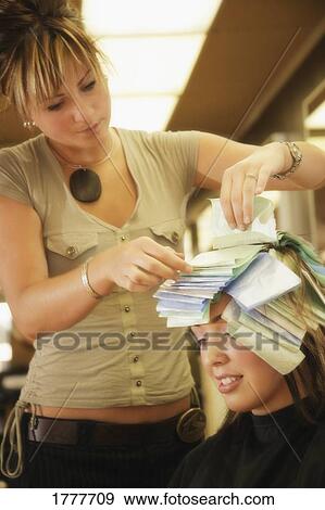 A stylist giving a young woman highlights View Large Photo Image Stock Photo - A stylist giving a young woman highlights. Fotosearch