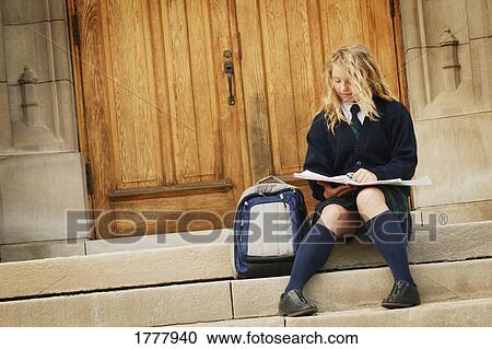 A teenage girl in a school uniform studying View Large Photo Image Stock Image - A teenage girl in a school uniform studying. Fotosearch