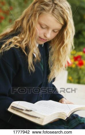 Stock Image - A teenage girl reading. Fotosearch