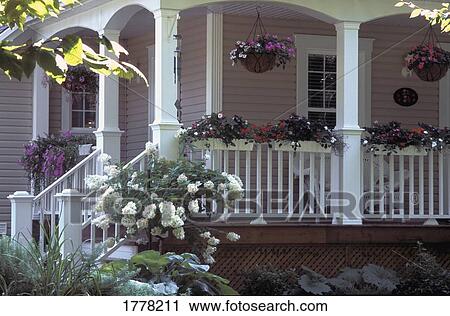 Stock Image - A veranda of a home with a potted garden displayed. Fotosearch