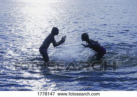 Stock Photo - A water fight. Fotosearch