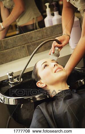A woman getting her hair rinsed at a hair salon View Large Photo Image Stock Photo - A woman getting her hair rinsed at a hair salon. Fotosearch