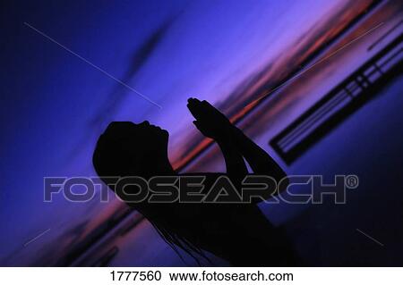 A woman in prayer View Large Photo Image Stock Image - A woman in prayer. Fotosearch