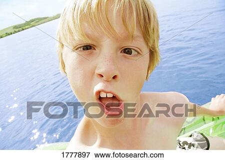 A young boy making a funny face View Large Photo Image Stock Photo - A young boy making a funny face. Fotosearch