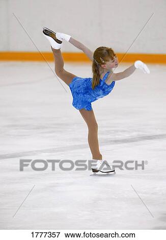 Stock Photo - A young girl figure skating. Fotosearch