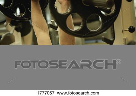 A young man bench pressing weights View Large Photo Image Stock Photo - A young man bench pressing weights. Fotosearch