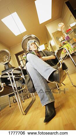A young woman at a hair salon View Large Photo Image Stock Photograph - A young woman at a hair salon. Fotosearch