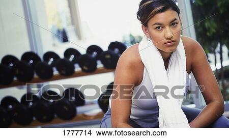 A young woman in a fitness center A young woman in a fitness centre View Large Photo Image Picture - A young woman in a fitness center A young woman in a fitness centre. Fotosearch