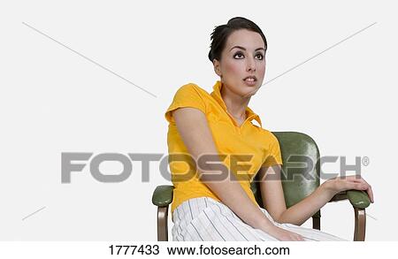 A young woman in a yellow shirt View Large Photo Image Stock Image - A young woman in a yellow shirt. Fotosearch