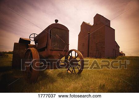 An old tractor and two granaries View Large Photo Image Stock Photo - An old tractor and two granaries. Fotosearch