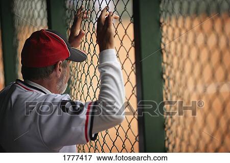 Baseball player in dugout View Large Photo Image Stock Photo - Baseball player in dugout. Fotosearch