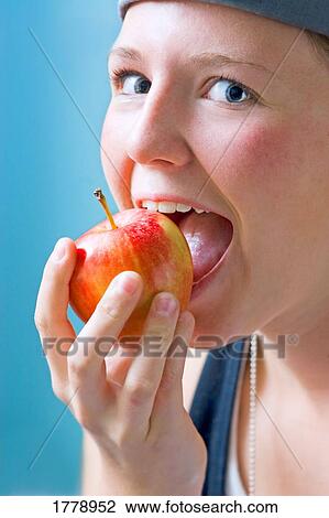 Biting into an apple View Large Photo Image Stock Image - Biting into an apple. Fotosearch