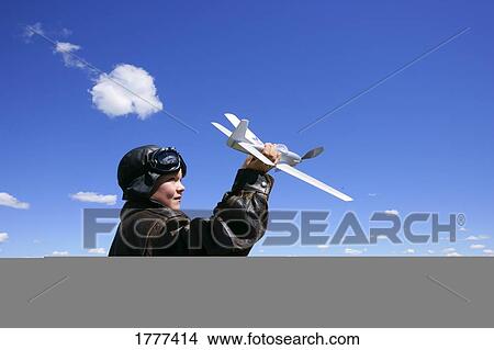Boy playing with airplane View Large Photo Image Picture - Boy playing with airplane. Fotosearch