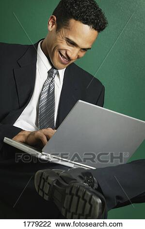 Stock Image - Businessman on laptop computer. Fotosearch