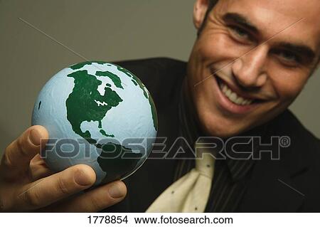 Businessman with the world in his hand View Large Photo Image Picture - Businessman with the world in his hand. Fotosearch
