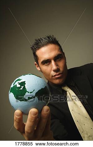 Businessman with the world in his hand View Large Photo Image Stock Photography - Businessman with the world in his hand. Fotosearch