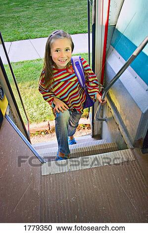 Stock Image - Child loads school bus. Fotosearch