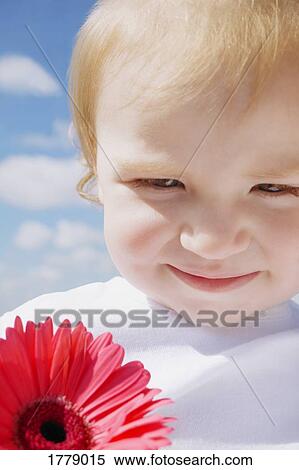 Stock Photography - Child with a flower. Fotosearch