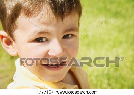 Stock Photo - close up portrait of small boy outside. Fotosearch