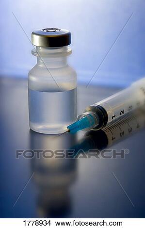 Closeup of a needle and vial View Large Photo Image Picture - Closeup of a needle and vial. Fotosearch