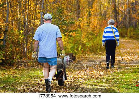 Couple doing fall maintenance View Large Photo Image Picture - Couple doing fall maintenance. Fotosearch