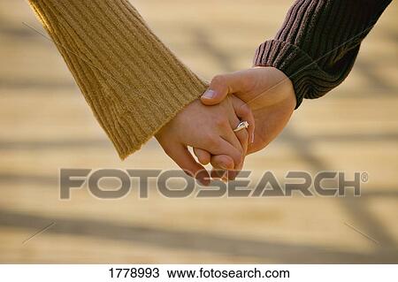 Couple hold hands View Large Photo Image Stock Image - Couple hold hands. Fotosearch