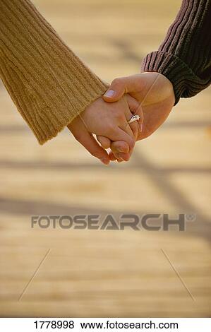 Couple holding hands View Large Photo Image Stock Photo - Couple holding hands. Fotosearch