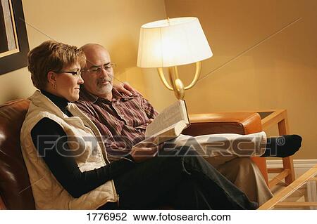 Couple reading a book View Large Photo Image Stock Image - Couple reading a book. Fotosearch