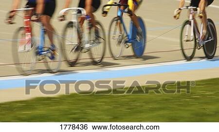 Cyclists racing on a track View Large Photo Image Stock Photograph - Cyclists racing on a track. Fotosearch