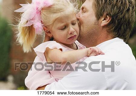 Picture - Father comforts daughter after a fall. Fotosearch