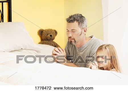Father praying with daughter View Large Photo Image Stock Image - Father praying with daughter. Fotosearch