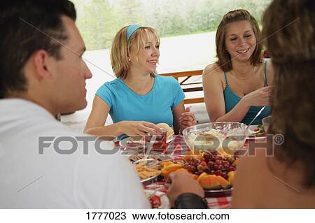 Friends at a picnic in the park View Large Photo Image Stock Image - Friends at a picnic in the park. Fotosearch