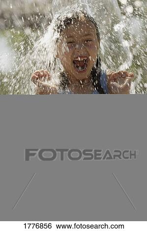 Girl playing in water View Large Photo Image Stock Photograph - Girl playing in water. Fotosearch