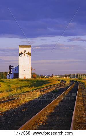 Grain elevator next to railway tracks View Large Photo Image Stock Photo - Grain elevator next to railway tracks. Fotosearch