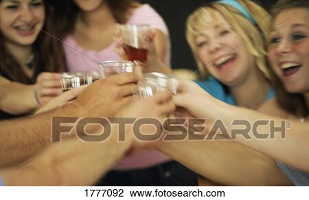 Stock Image - Group of friends celebrating with drinks. Fotosearch